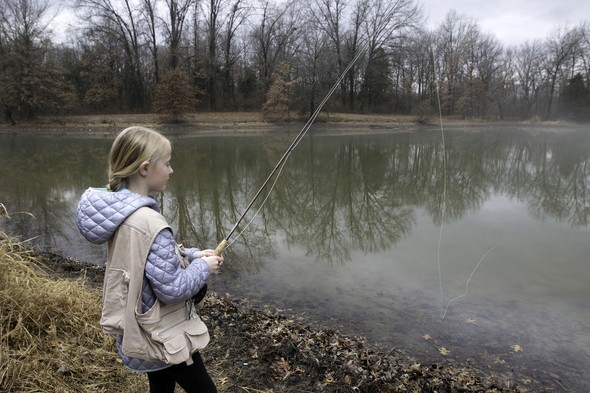 Girl trout fishing at lake