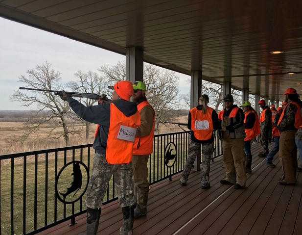 Participants of a novice hunt event receive coaching on wingshooting from hunters.