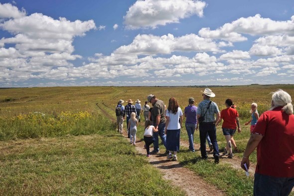 Several people take a guided tour of Dunn Ranch Prairie.