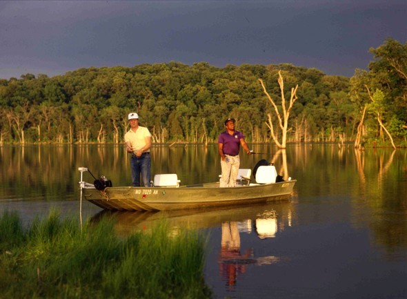 Two people fishing from a boat on Harmony Mission Lake.