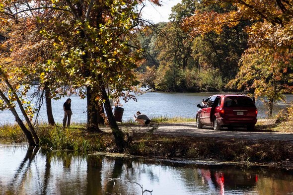 A group of people park their van to enjoy a view of the lake at Poosey Conservation Area.