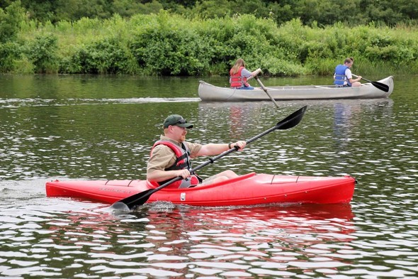 An MDC staff member kayaks on a lake.