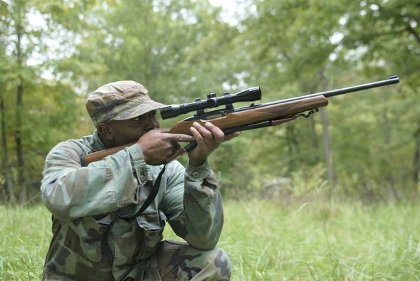 man shooting a .22 rifle