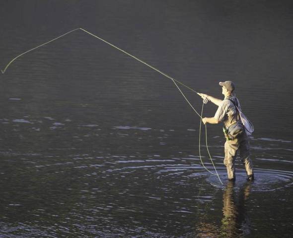 man trout fishing