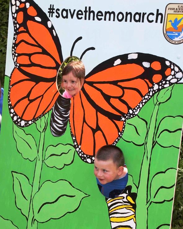 Children posing with Save the Monarchs exhibit