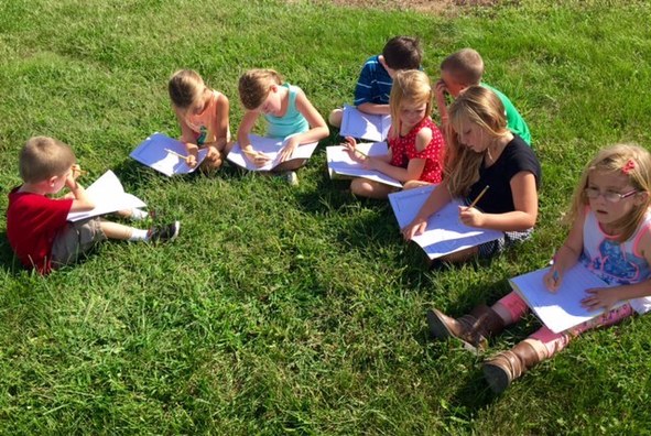young students enjoy learning about nature outside