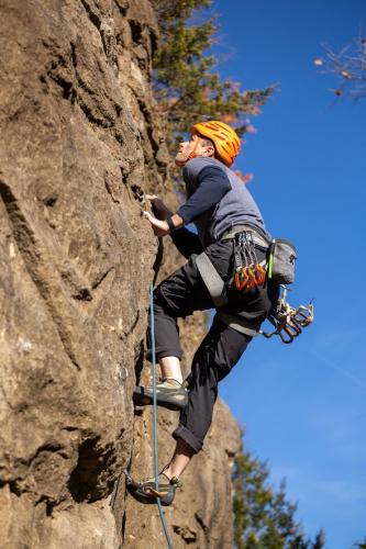 A man rock climbs at Rockwoods Reservation