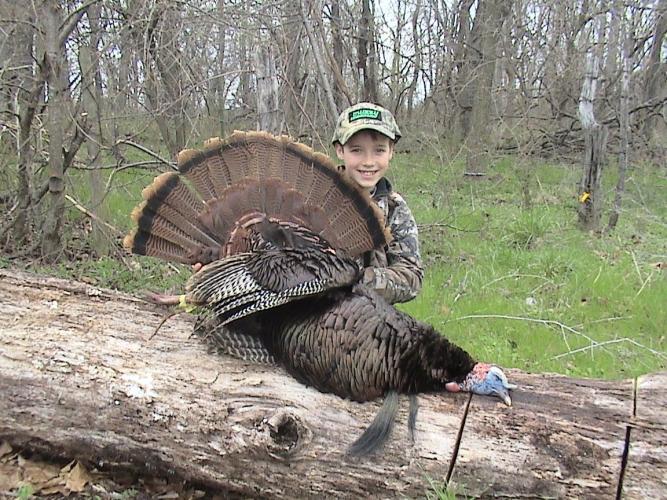 Young turkey hunter with gobbler