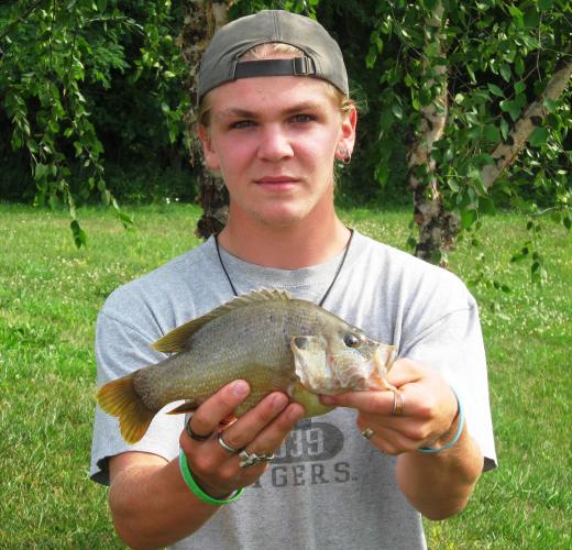 Bowen Dockery holding his new state-record green sunfish.