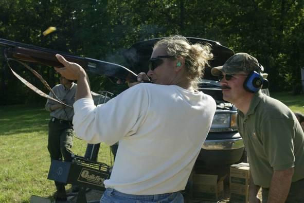 Lady shooting a shotgun