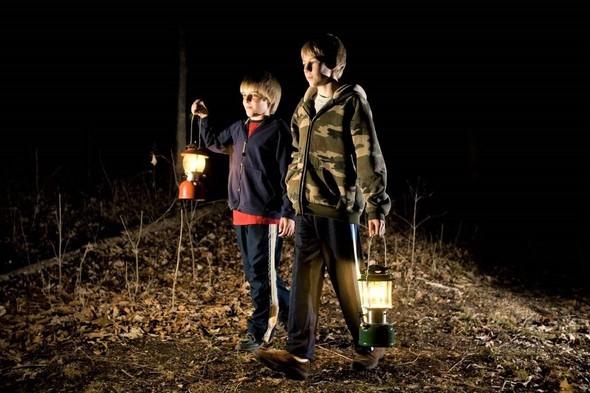 Two boys take a night hike with lanterns