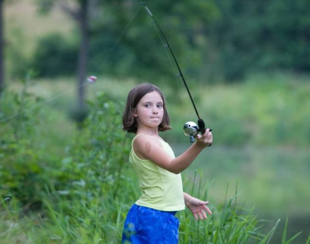 A young girl casts her line at Roaring River State Park.