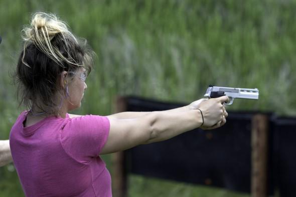 Woman aims handgun