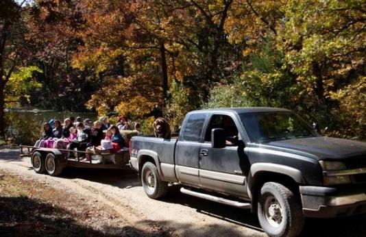 A truck pulls a trailer of people for a fall color tour of Poosey Conservation Area.