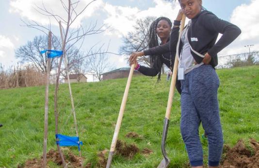 two girls planting native tress