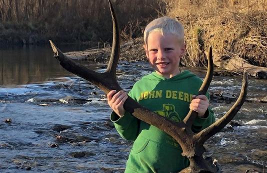 Sam Clarkson holds an elk antler he found