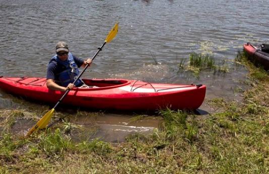 MDC staff member on a kayak