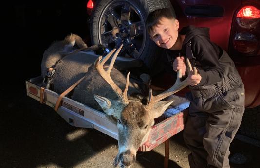 Alex Drew poses with a buck he harvested during opening day of 2022 firearms deer season