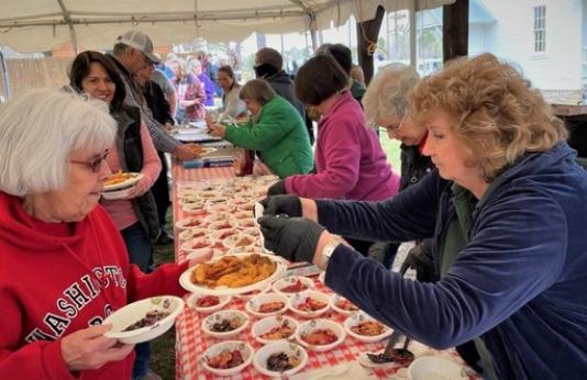 People sample food at Twine Pines Heritage Day