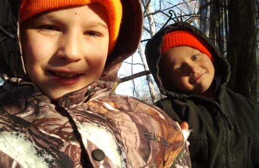 Justin and Julian Floyd enjoy time in the deer stand with their dad