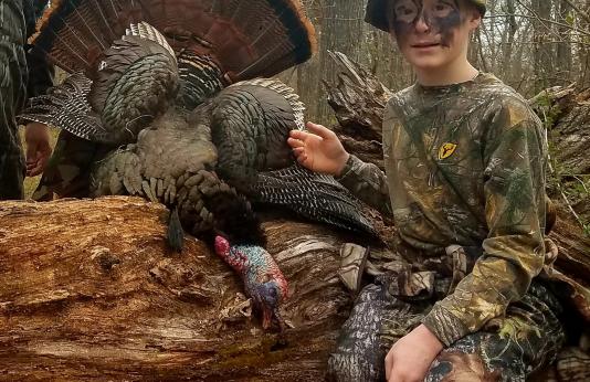 Young turkey hunter Auggie Boyt posed with harvested turkey