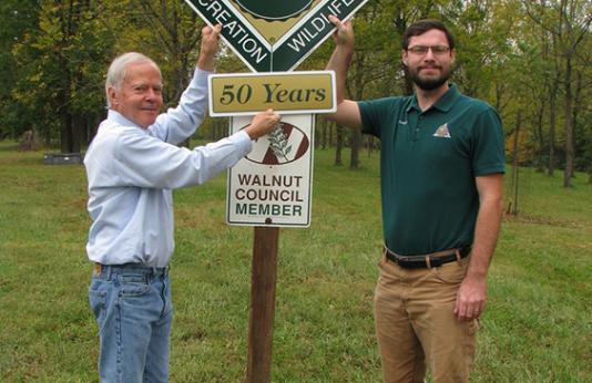 Man getting award from MDC forester for 50 Years in the Tree Farm System
