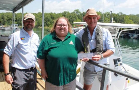Check presentation from MDC staff to two people at Harbor Marina in Branson