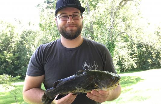 Cody Sparkman holds his new state record black bullhead catfish.