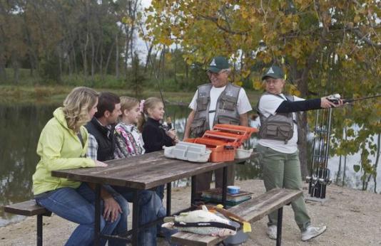 A family learns about fishing from two experienced anglers.