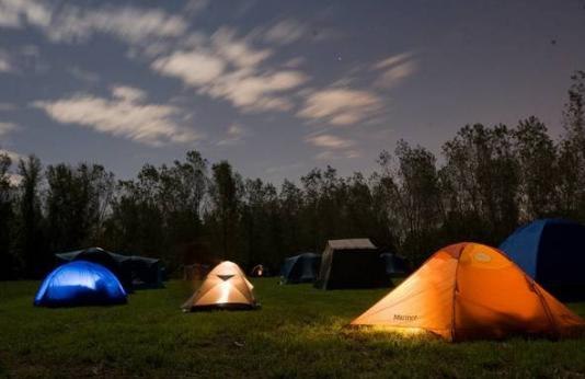 Tents spread out at night.