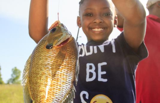 Young angler shows off her catch.