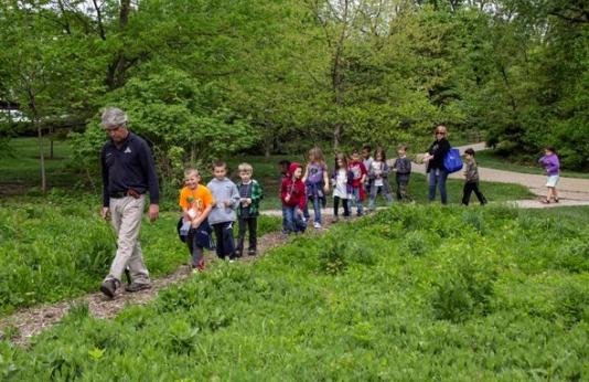 MDC staff lead children on a nature walk at the Discovery Center.