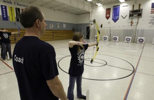 Teachers training on archery range.
