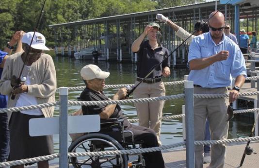 MDC staff helping special needs people fish.