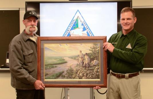 David Peters (left) is presented with the 2018 HED MDC Volunteer Instructor of the Year for the St. Louis Region Award by MDC Outdoor Skills Specialist Conrad Mallady