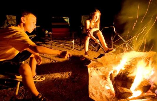 two kids at a campfire