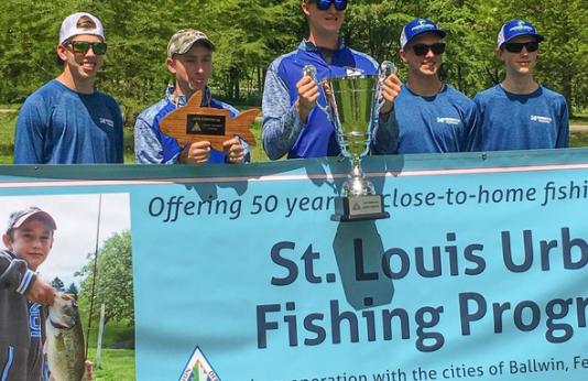 The Marquette High School Fishing Team poses with their trophy.