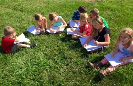 young students enjoy learning about nature outside